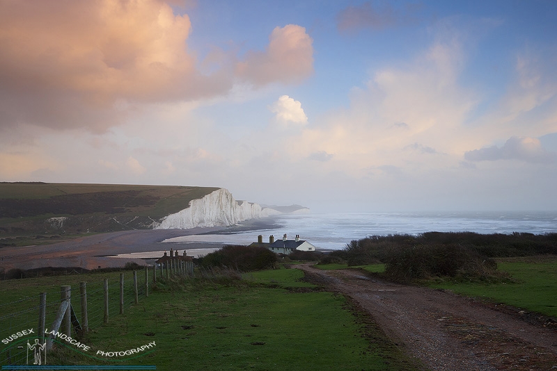 slides/Passing Storm.jpg coast guard cottages east sussex coastal coast blue sky winter sunny seaside snow cold bitter panoramic cliffs white lighthouse seven sisters country park cuckmere haven river beach storm fence road Passing Storm